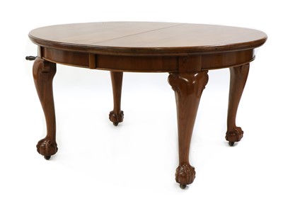 Lot 328 - A walnut extending dining table