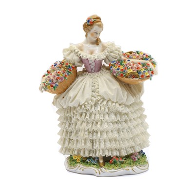 Lot 238 - A Dresden Sitzendorf porcelain lace figurine of a flower seller