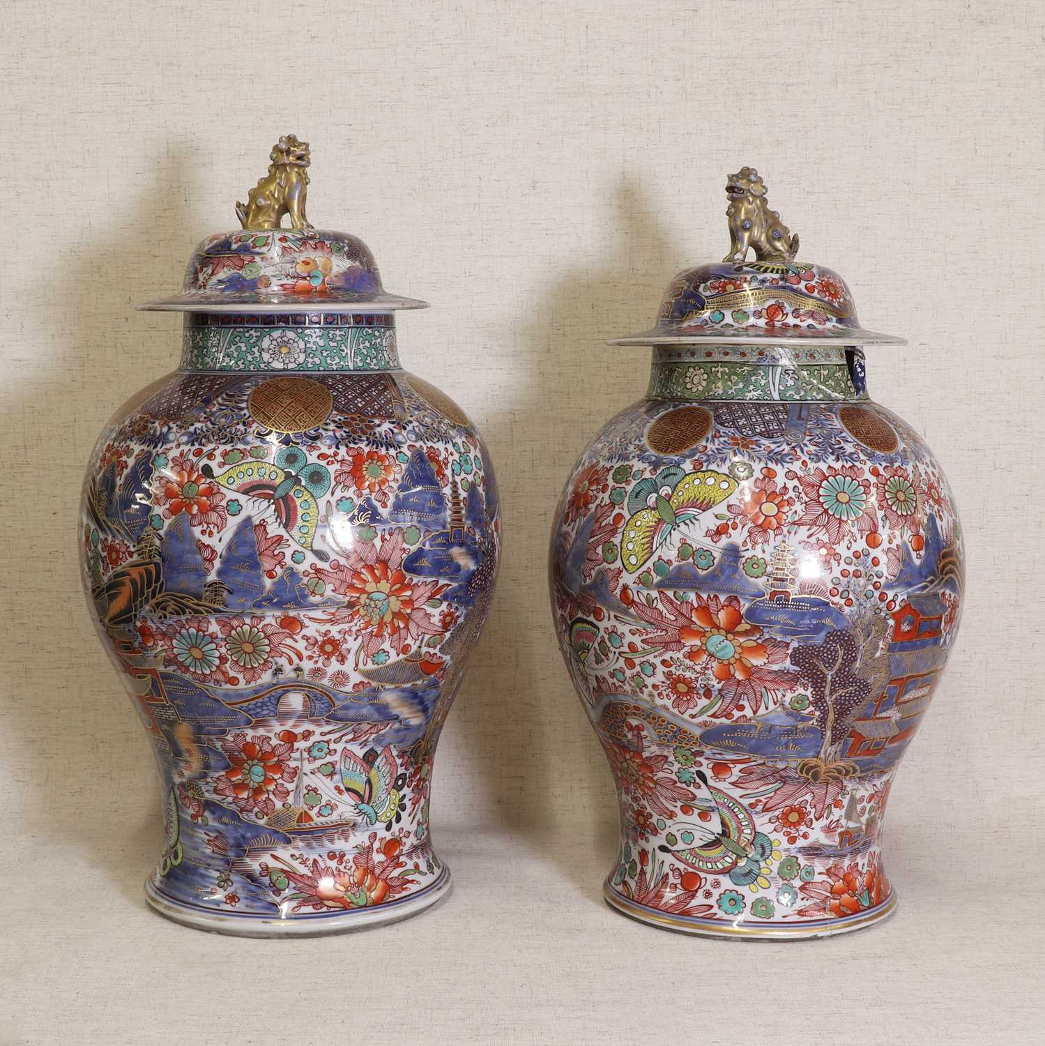 Lot 44 - Two Chinese clobbered blue and white vases and covers