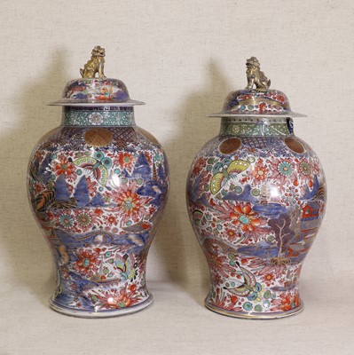 Lot 44 - Two Chinese clobbered blue and white vases and covers