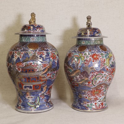 Lot 44 - Two Chinese clobbered blue and white vases and covers