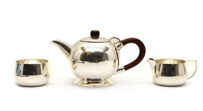Lot 59 - A mid-century faintly planished three piece tea service