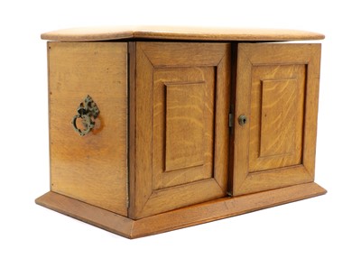 Lot 260 - An Edwardian honey oak stationery cabinet
