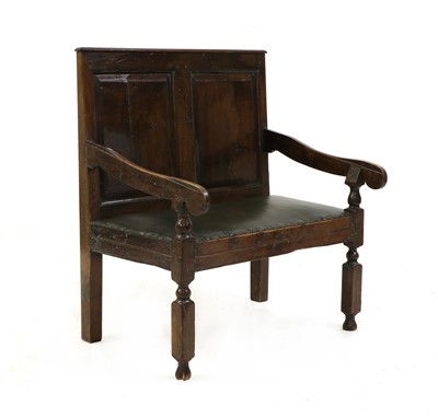 Lot 351 - An oak panelled back settle