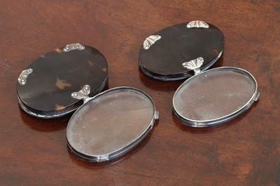 Lot 135 - A graduated pair of white metal and tortoiseshell folding magnifying glasses