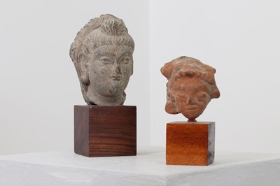 Lot 237 - A carved grey schist fragmentary bust of Buddha