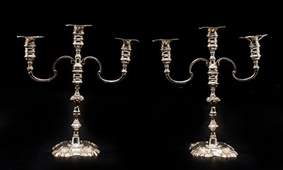 Lot 9 - A pair of twin-branch cast silver candlesticks