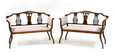 Lot 345 - A pair of Edwardian rosewood and mahogany salon settees