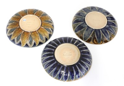 Lot 22 - A Doulton Lambeth teapot and three matched cups and saucers
