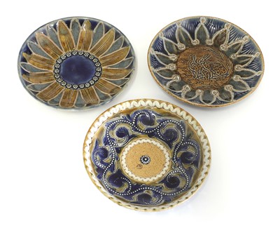 Lot 22 - A Doulton Lambeth teapot and three matched cups and saucers