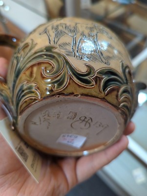 Lot 22 - A Doulton Lambeth teapot and three matched cups and saucers