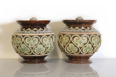 Lot 15 - A pair of Doulton Lambeth stoneware vases and covers