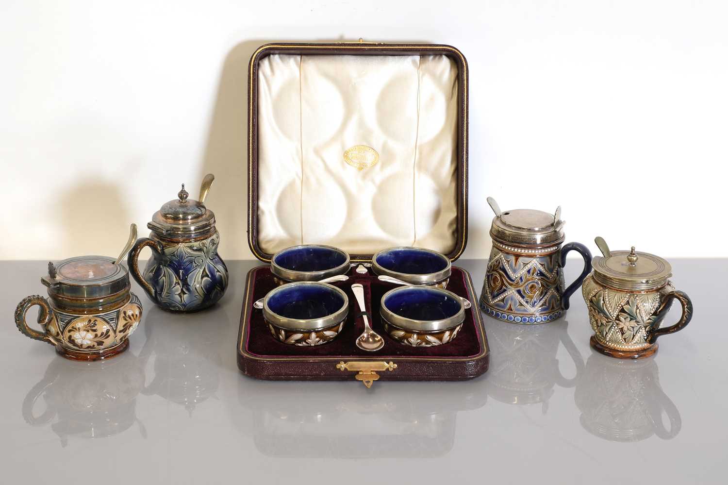 Lot 47 - A cased set of four Doulton Lambeth stoneware cruets