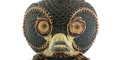 Lot 55 - A Doulton Lambeth figural stoneware jar and cover