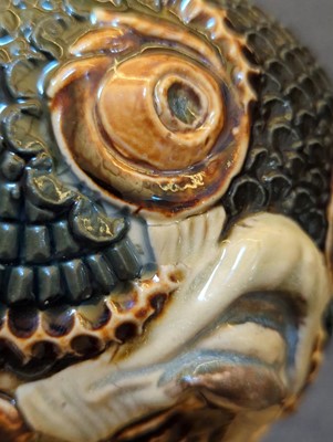 Lot 55 - A Doulton Lambeth figural stoneware jar and cover
