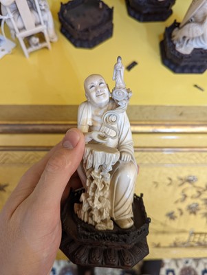 Lot 423 - A set of eighteen carved ivory figures