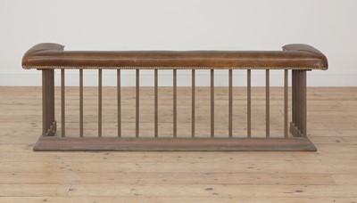 Lot 536 - A brass and leather upholstered club fender