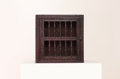 Lot 245 - A carved oak hanging glass cupboard