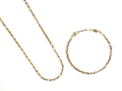 Lot 414 - A three colour gold barley link chain and bracelet suite