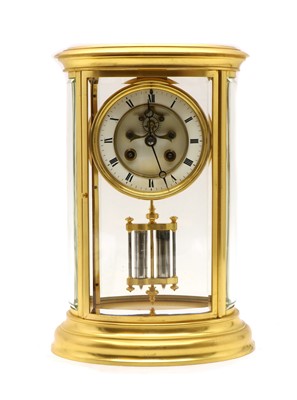 Lot 211 - A French four glass brass mantel clock