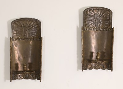 Lot 110 - A pair of pressed brass wall sconces