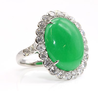 Lot 463 - A dyed jade and diamond oval cluster ring