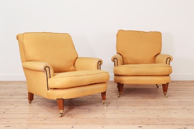 Lot 594 - A pair of club armchairs in the manner of Howard & Sons