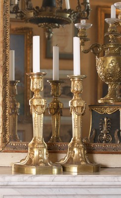 Lot 113 - A pair of Louis XVI gilt-bronze candlesticks