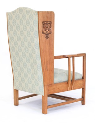 Lot 67 - An Arts and Crafts oak wing-back armchair