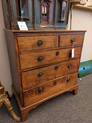 Lot 385 - A George III elm chest of drawers