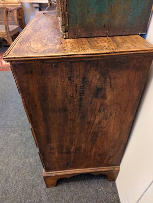 Lot 385 - A George III elm chest of drawers