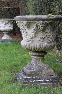 Lot 399 - A pair of weathered composite stone campana urns