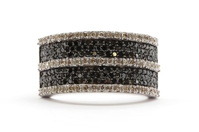 Lot 152 - A 9ct white gold diamond and black diamond ring