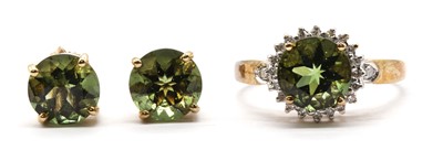Lot 141 - A 9ct gold moldavite and diamond cluster ring
