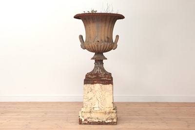 Lot 407 - A cast iron urn and stand