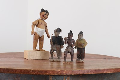 Lot 232A - An articulated carved wooden doll