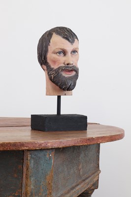 Lot 200 - A carved and painted wooden head of a saint