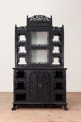 Lot 128 - A carved hardwood display cabinet