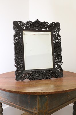 Lot 129 - A pierced and carved cedar mirror
