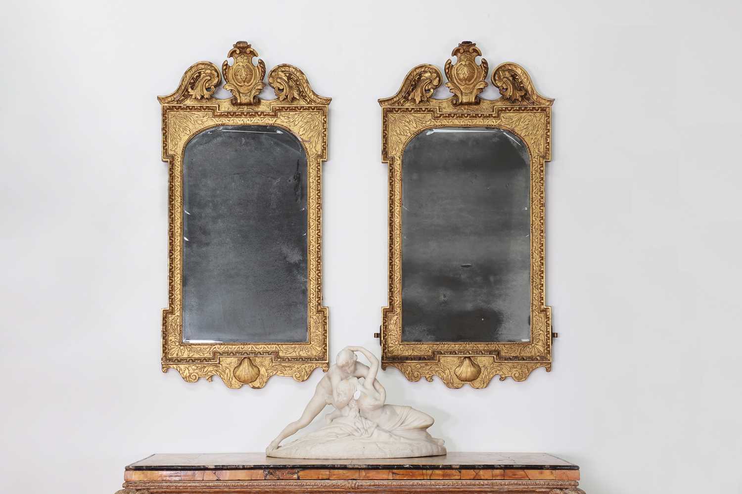 Lot 184 - A pair of George II gilt gesso pier mirrors