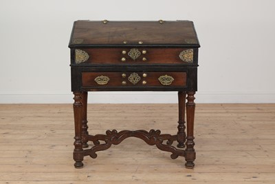 Lot 122 - A hardwood, ebony and brass desk on stand