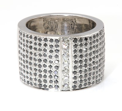 Lot 299 - An 18ct white gold white and black diamond set band ring