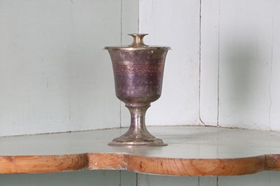 Lot 323 - A small unmarked silver communion cup with paten