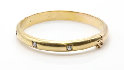 Lot 58 - An Edwardian diamond set hollow hinged bangle