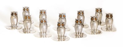 Lot 23 - A set of twelve matched silver owl place card holders