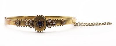 Lot 25 - A gold sapphire, diamond and split pearl bangle
