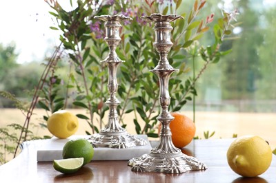 Lot 351 - A pair of George II cast silver candlesticks