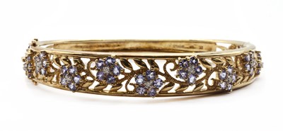 Lot 296 - A 9ct gold tanzanite and diamond bangle