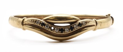 Lot 412 - A gold cubic zirconia set bangle