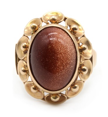 Lot 205 - A Polish gold goldstone glass ring